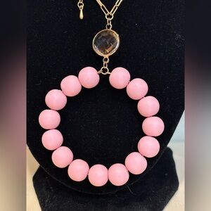 Necklace with a 32 inch long chain. Pendant is a little over 3 inches.